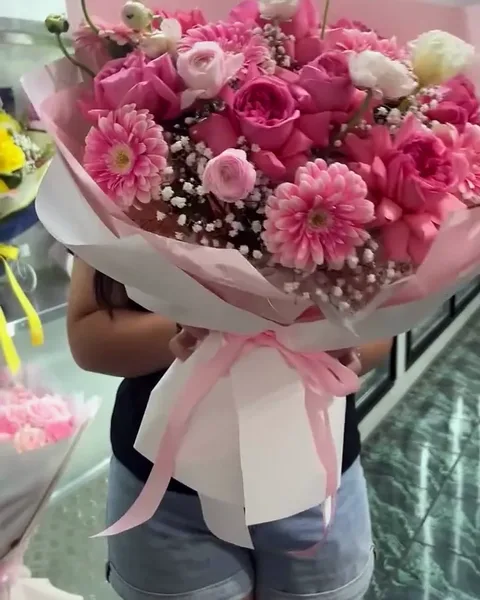 A bright mix of hot pink flowers in pink wrap