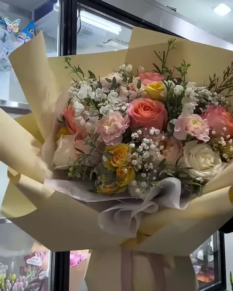 Peach and cream garden flowers in a loose bouquet